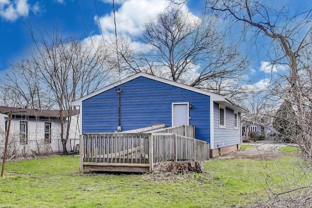 back of property featuring a yard and a deck