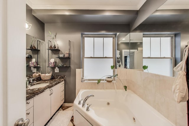 bathroom featuring a jetted tub and vanity