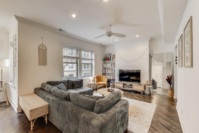 living room featuring crown molding, visible vents, ceiling fan, dark wood-style floors, and recessed lighting