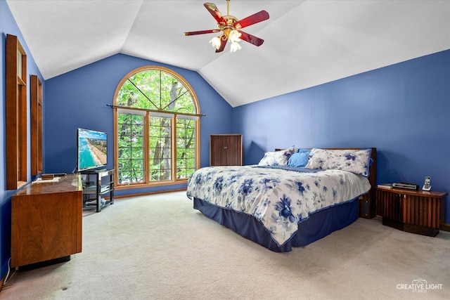 carpeted bedroom featuring vaulted ceiling and a ceiling fan