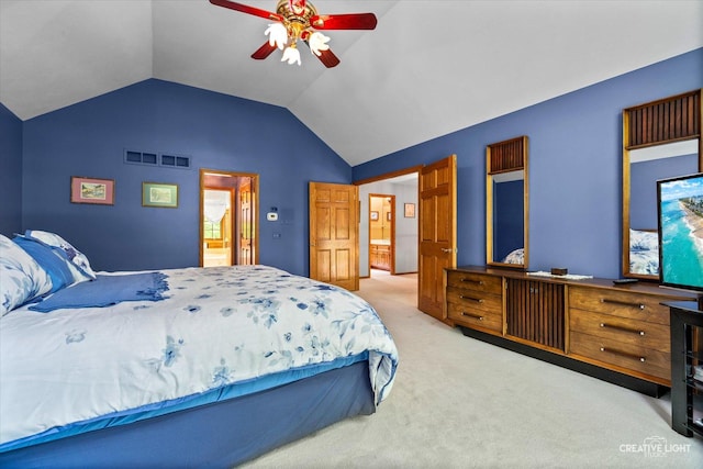carpeted bedroom with vaulted ceiling and a ceiling fan