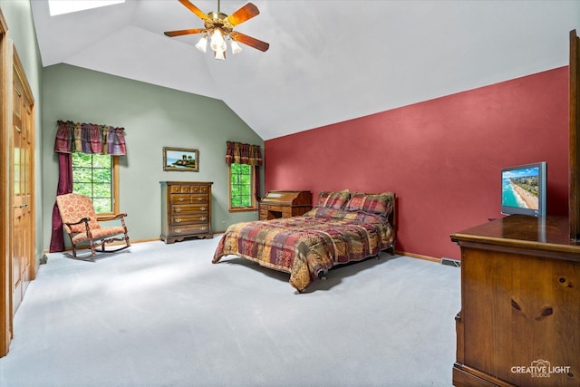 carpeted bedroom with baseboards, vaulted ceiling, multiple windows, and a ceiling fan