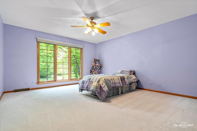 bedroom with baseboards, carpet flooring, and a ceiling fan