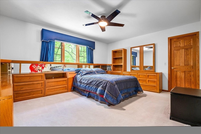 bedroom featuring light colored carpet and ceiling fan