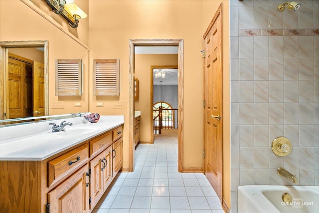 full bath featuring tile patterned floors, vanity, baseboards, and shower / bathtub combination