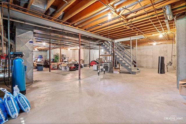unfinished basement featuring stairway