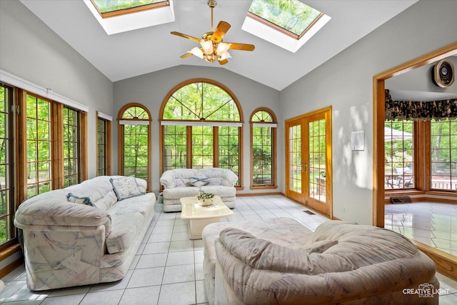 living area with a skylight, plenty of natural light, vaulted ceiling, and ceiling fan