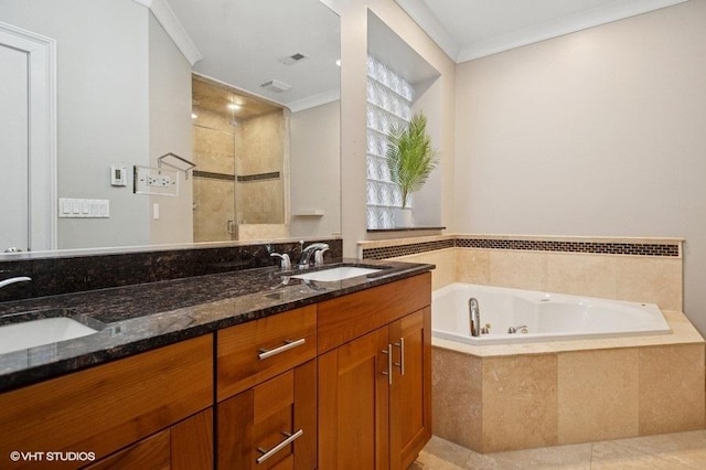 full bathroom with a shower stall, ornamental molding, a jetted tub, and a sink