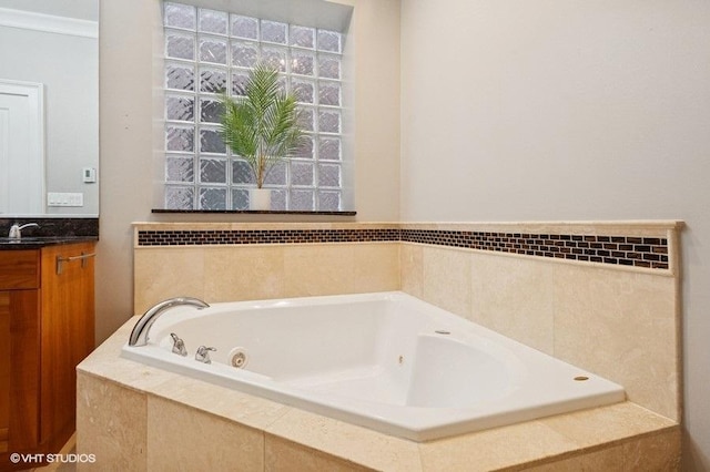 full bath with vanity and a jetted tub