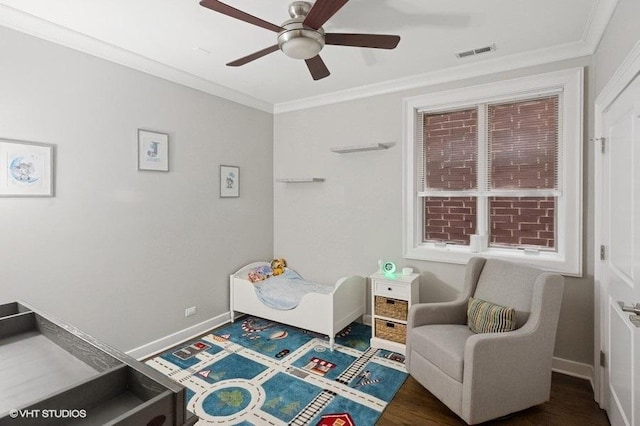 bedroom featuring wood finished floors, a ceiling fan, crown molding, visible vents, and baseboards