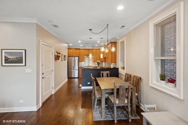 dining room with crown molding, dark wood finished floors, baseboards, and recessed lighting