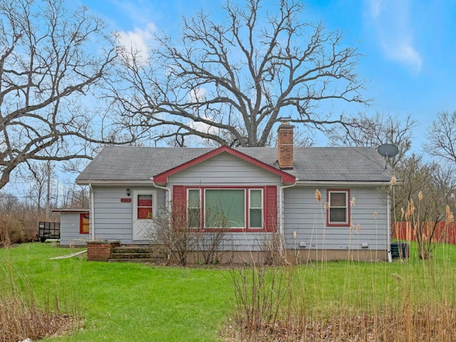 4363 W Kennedy Dr, Gurnee, IL 60031 - view of front of house featuring a chimney, a front yard, and a shingled roof