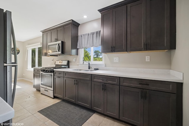 4363 W Kennedy Dr, Gurnee, IL 60031 - kitchen featuring appliances with stainless steel finishes, light countertops, light tile patterned flooring, recessed lighting, and dark brown cabinetry