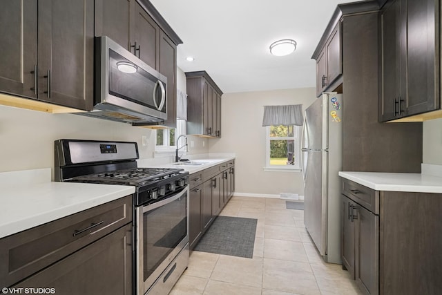 4363 W Kennedy Dr, Gurnee, IL 60031 - kitchen with stainless steel appliances, dark brown cabinets, light countertops, and healthy amount of natural light