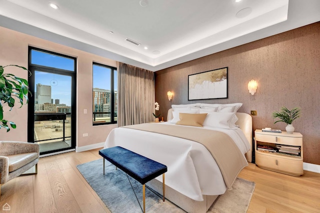 bedroom featuring recessed lighting, light wood-style flooring, visible vents, and access to outside