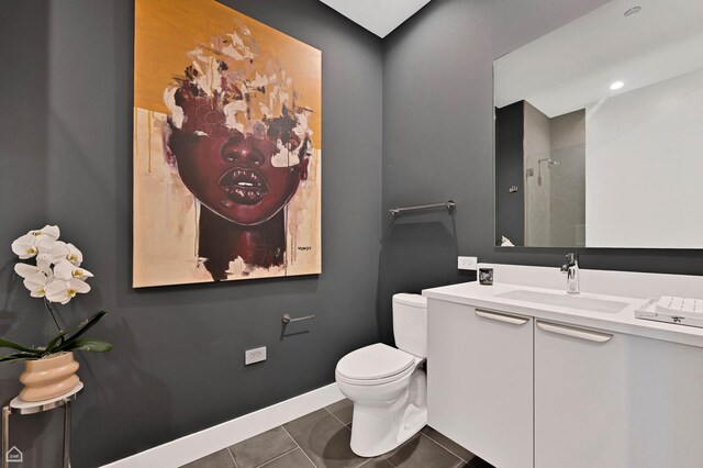 bathroom with tile patterned flooring, vanity, and toilet
