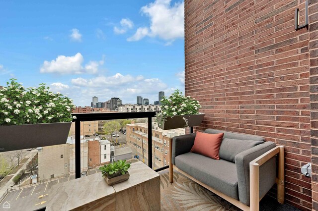 balcony with a view of city and an outdoor hangout area