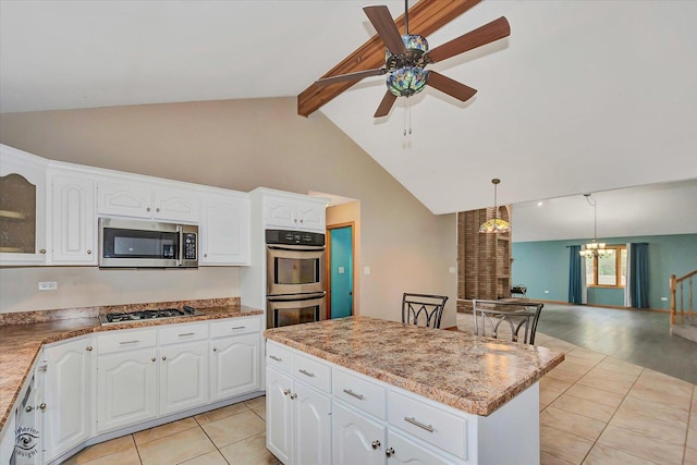 kitchen featuring appliances with stainless steel finishes, beam ceiling, ceiling fan with notable chandelier, light tile patterned floors, and glass insert cabinets