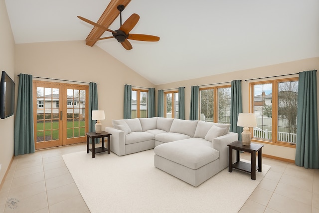living area with baseboards, ceiling fan, light tile patterned flooring, and beamed ceiling