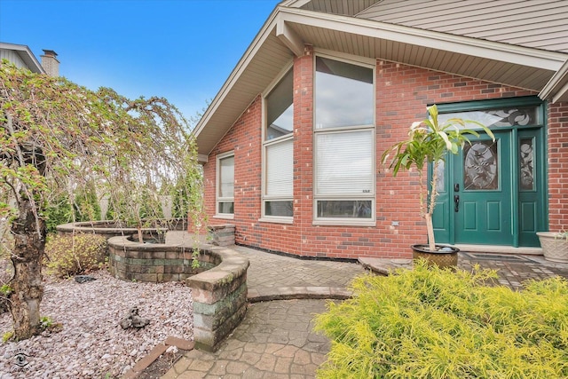 exterior space featuring a patio area and brick siding