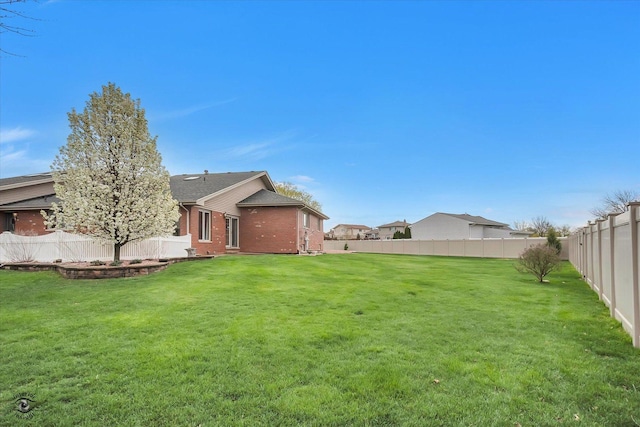 view of yard with a fenced backyard
