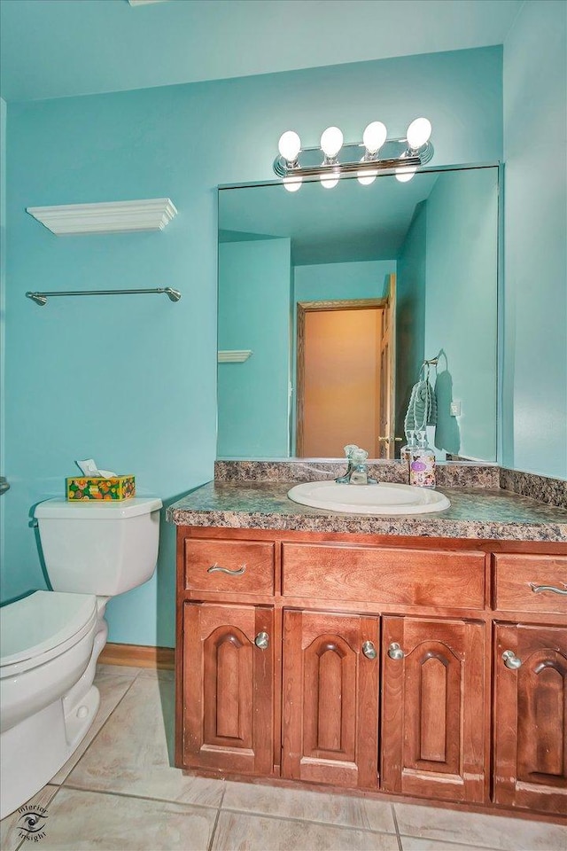 bathroom with tile patterned floors, vanity, and toilet