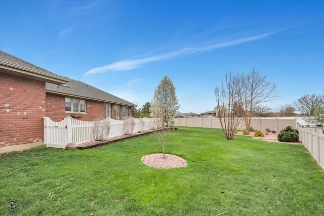 view of yard with a fenced backyard