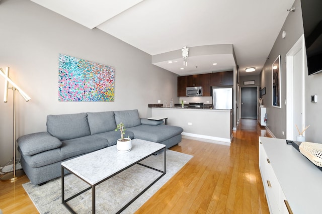 living area featuring light wood-style floors and recessed lighting