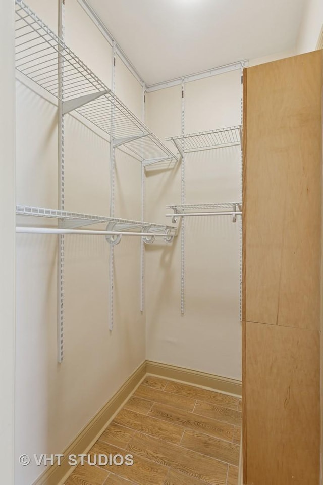 spacious closet with wood finished floors