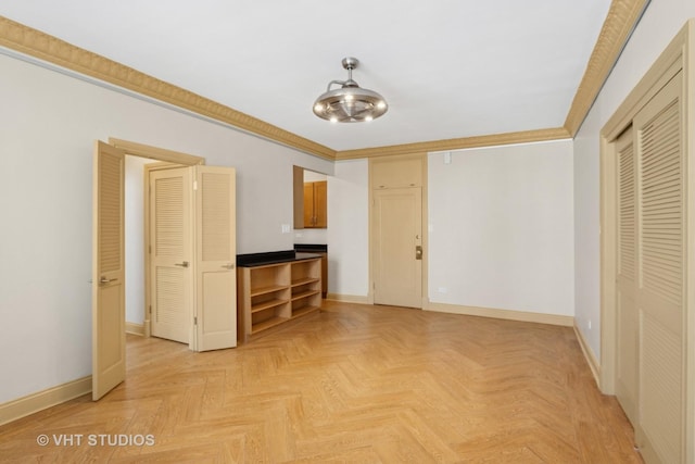 interior space featuring crown molding and baseboards