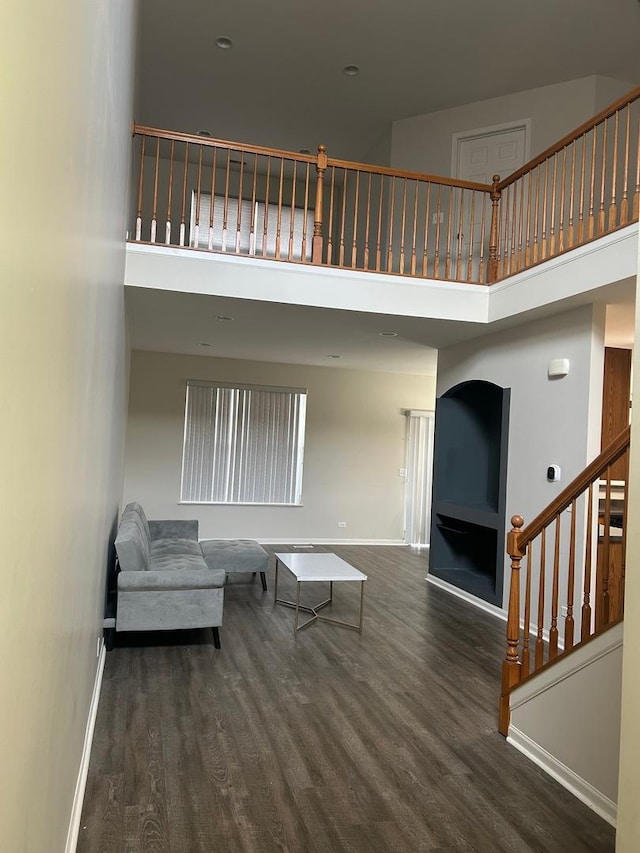 567 S Jade Ln, Round Lake, IL 60073 - living area with stairs, a high ceiling, baseboards, and wood finished floors