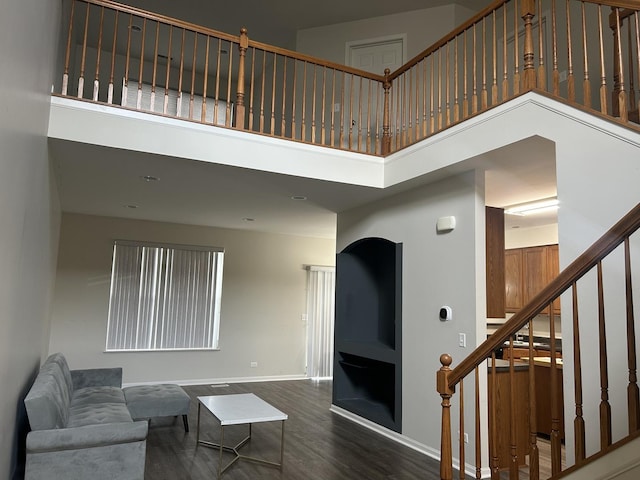 567 S Jade Ln, Round Lake, IL 60073 - living area with baseboards, a high ceiling, stairs, and wood finished floors