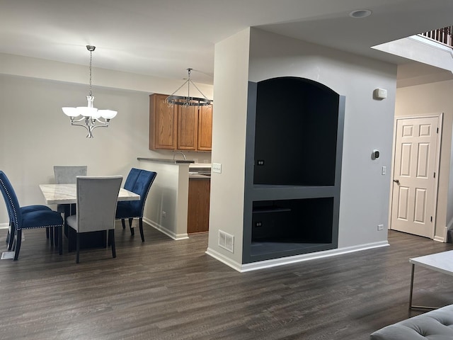 567 S Jade Ln, Round Lake, IL 60073 - dining area with baseboards, a notable chandelier, dark wood-style floors, and visible vents