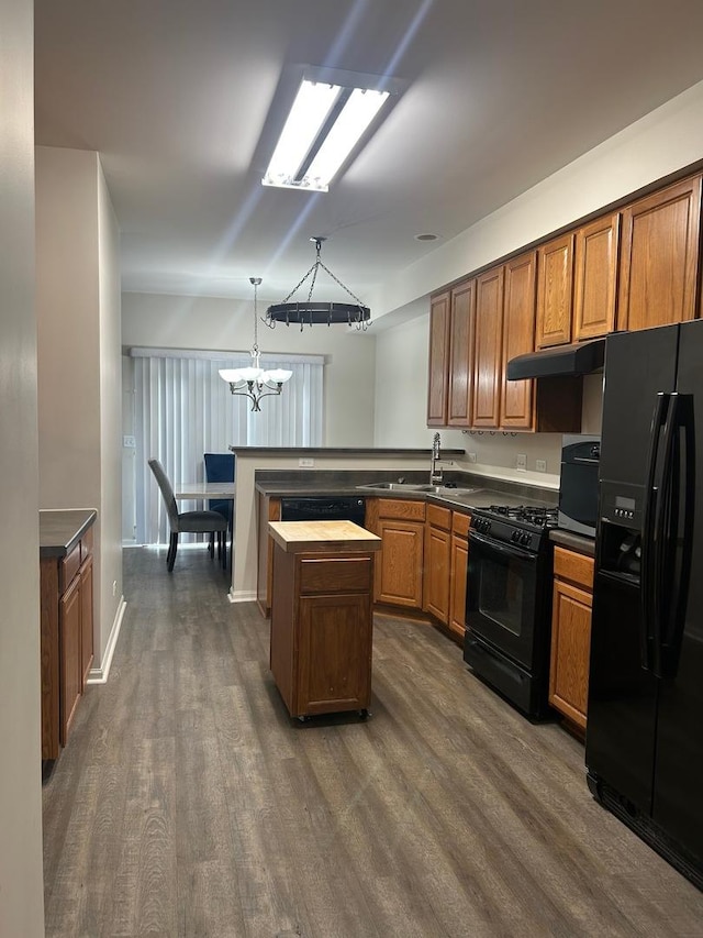 567 S Jade Ln, Round Lake, IL 60073 - kitchen with brown cabinets, a sink, a chandelier, dark wood-type flooring, and black appliances