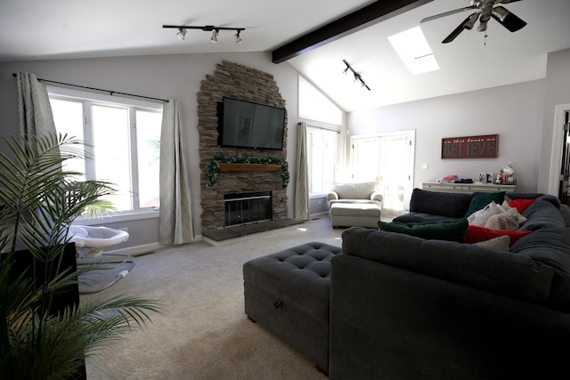 16725 92nd Ave, Orland Hills, IL 60487 - carpeted living room with rail lighting, a ceiling fan, a skylight, a stone fireplace, and beam ceiling