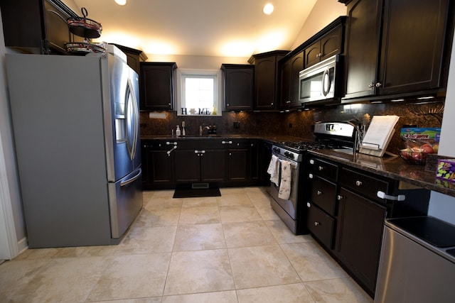16725 92nd Ave, Orland Hills, IL 60487 - kitchen featuring stainless steel appliances, backsplash, a sink, dark stone countertops, and light tile patterned flooring