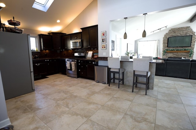 16725 92nd Ave, Orland Hills, IL 60487 - kitchen with stainless steel appliances, lofted ceiling, a skylight, open floor plan, and dark countertops