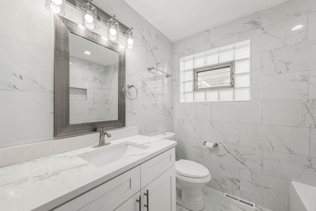 6330 W 64th Pl, Chicago, IL 60638 - full bath featuring toilet, tile walls, visible vents, marble finish floor, and vanity