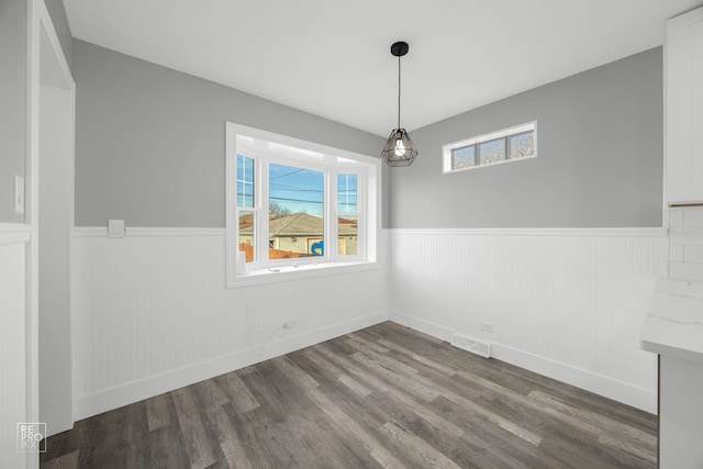 6330 W 64th Pl, Chicago, IL 60638 - unfurnished dining area with wainscoting, baseboards, wood finished floors, and visible vents
