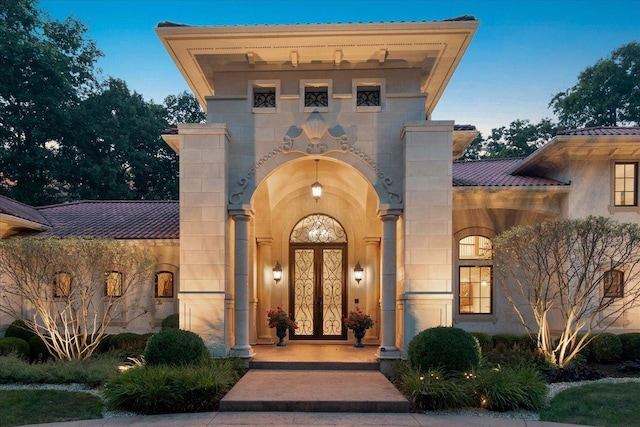 property entrance featuring a tiled roof