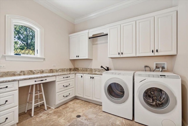 washroom featuring ornamental molding, cabinet space, a sink, and independent washer and dryer