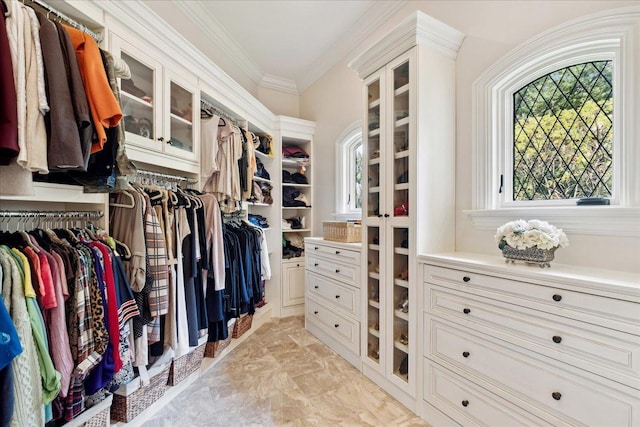 walk in closet featuring marble finish floor