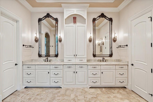 full bath featuring ornamental molding, a sink, and double vanity