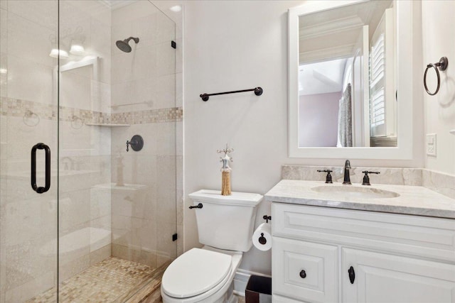 full bath with vanity, toilet, a stall shower, and ornamental molding