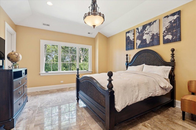 bedroom with vaulted ceiling, visible vents, and baseboards