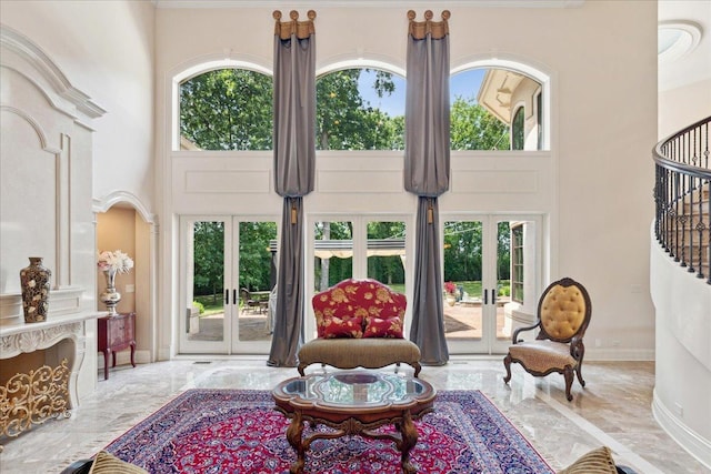 living room featuring marble finish floor, a high ceiling, and french doors