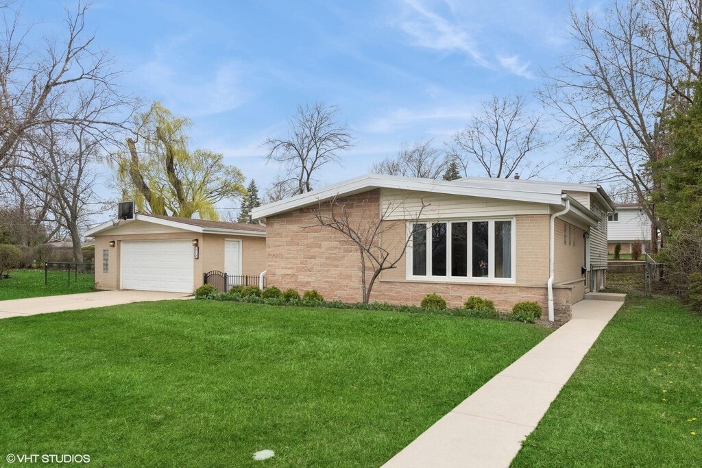 418 Warren Rd, Glenview, IL 60025 - view of front of home with brick siding, driveway, a front yard, and fence