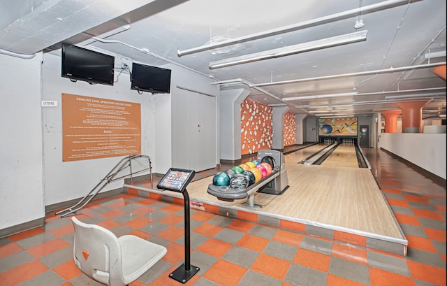 game room with a bowling alley and baseboards