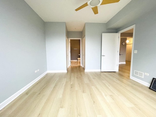 unfurnished bedroom with light wood-style floors, baseboards, and a ceiling fan