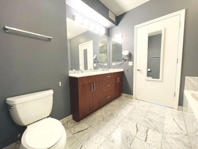 full bathroom featuring marble look tiles, a relaxing tiled tub, toilet, and double vanity